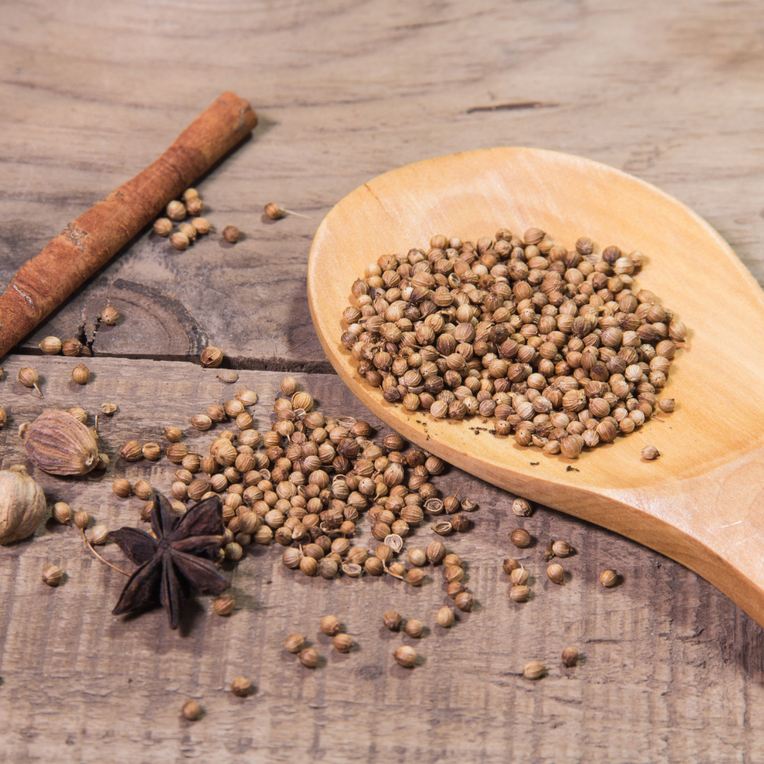 This is a picture of spices spread out and a spoon on the side.